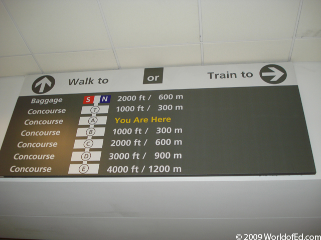 A distance sign within the Atlanta airport.