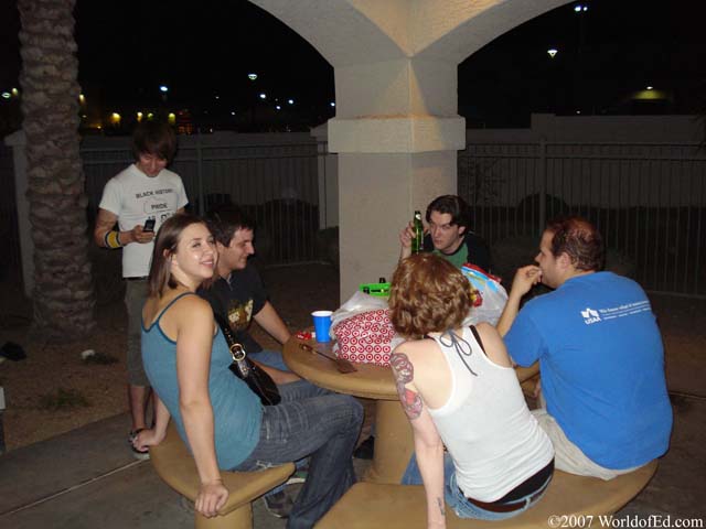 A group of people sitting at an outdoor table.