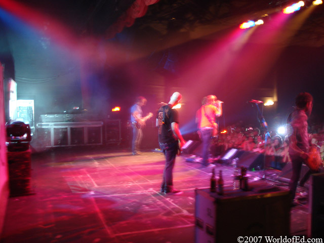 A blurry picture of Cartel performing on stage.