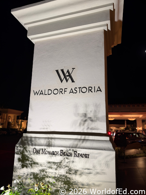 The entrance sign lit up at night.