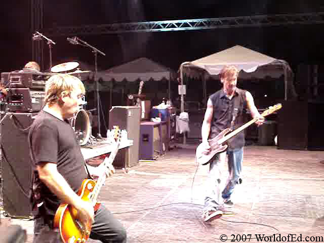 Jay Bentley and Brian Baker performing on stage.