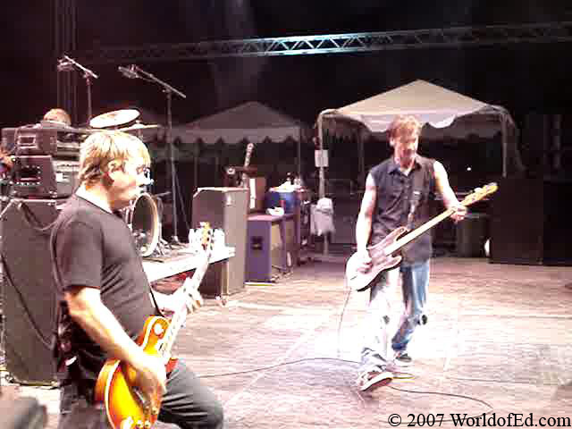 Jay Bentley and Brian Baker performing on stage.
