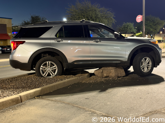 A car that ran over a boulder.