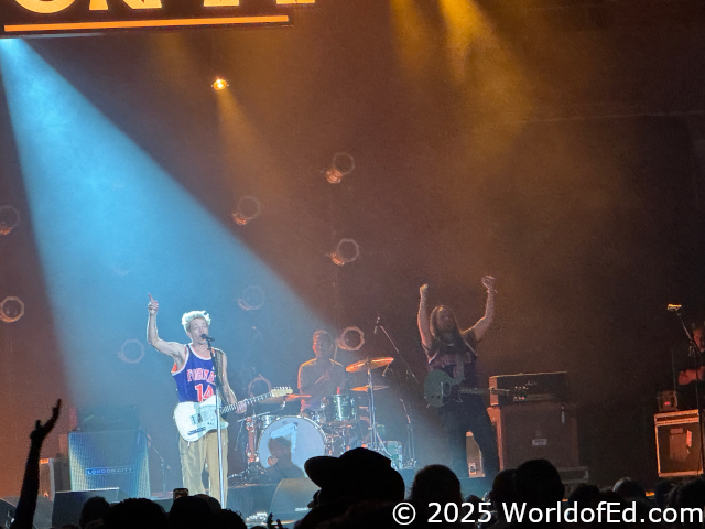 The band with their hands up.