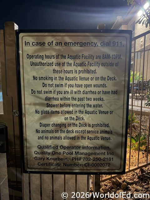 A sign with regulations on it at the pool.