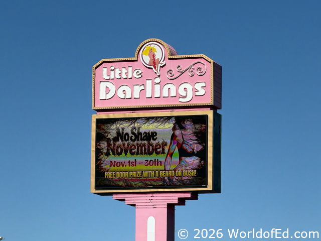 A bizarre sign outside of a strip club.
