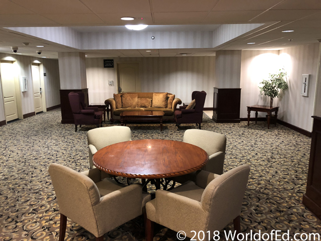 An interior of a large lobby in a Hampton Inn hotel.