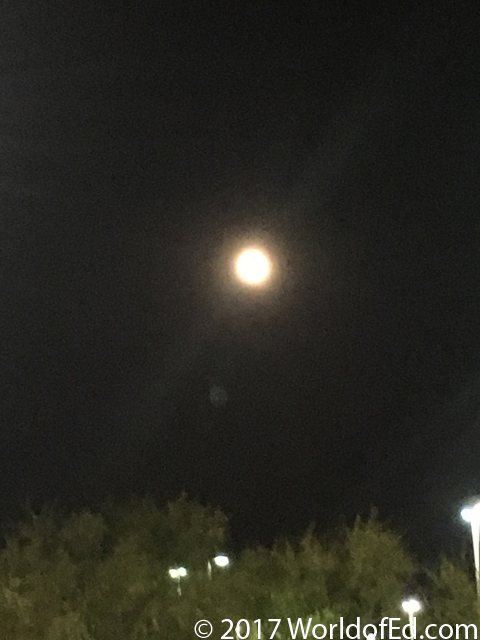 A grainy picture of the moon in the sky.
