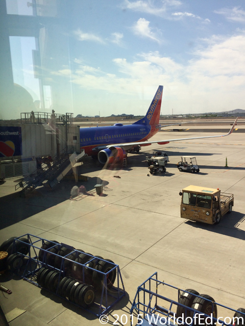 A plane sitting at an airline gate.