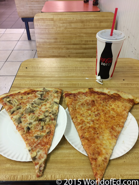Two slices of pizza on two plates.