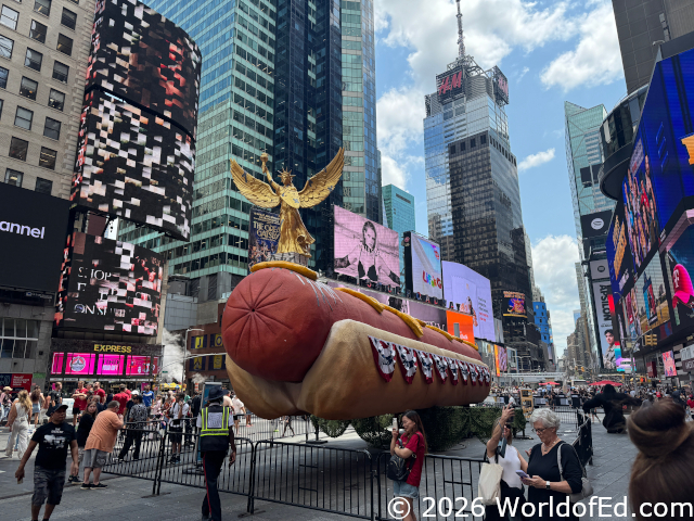 A statue on top of a truck shaped like a hot dog.