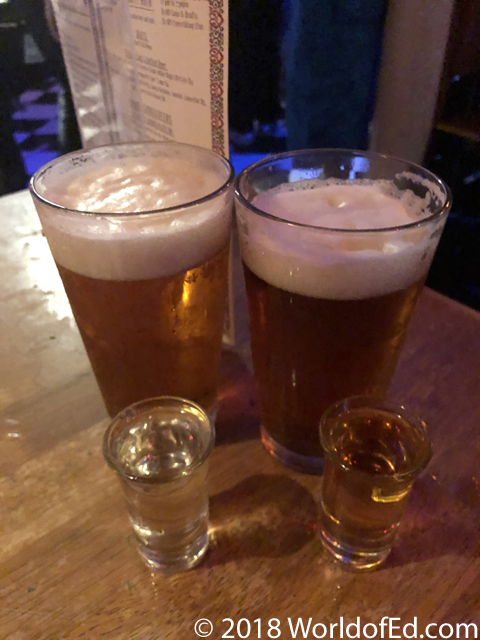 Beer and shots on a table in a bar.
