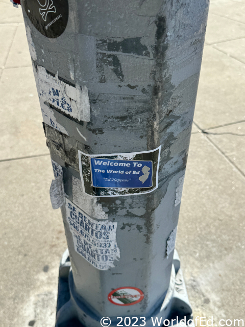 A World of Ed sticker on a lamppost.