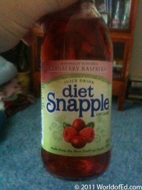 A bottle of Diet Snapple being held in a hand.