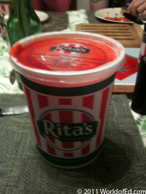Cherry Rita's Italian Ice in a container on a table.