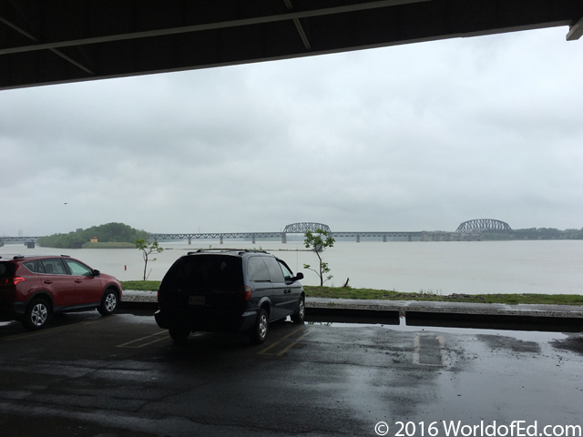 Cars parked next to a river.