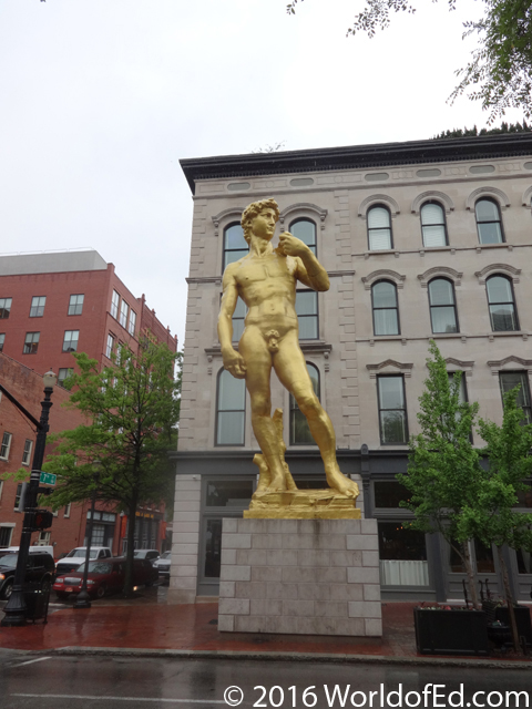 A gold statue of a naked Greek.