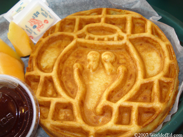 A waffle with an elephant face shaped in it.