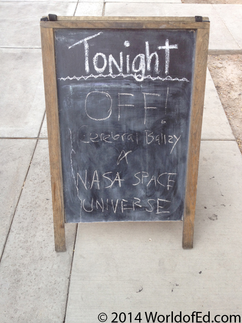 A sidewalk sign advertising the show.
