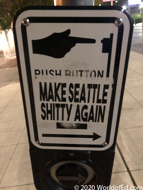 A sticker on a walk sign.