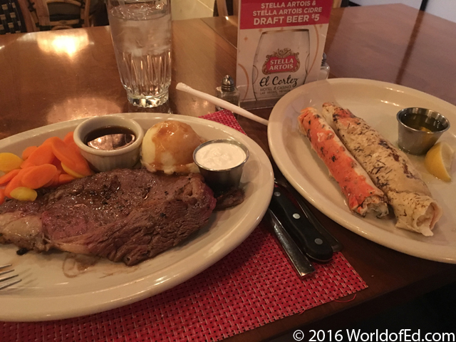 Prime rib and crab legs on a plate in a restaurant.