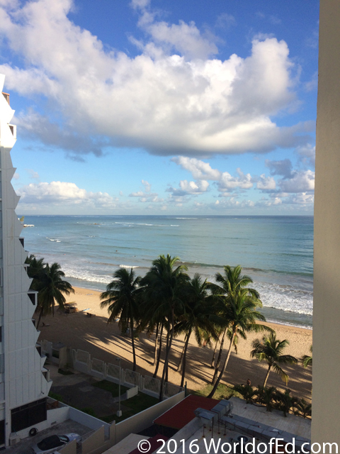 A view of the beach from a high hotel balcony.