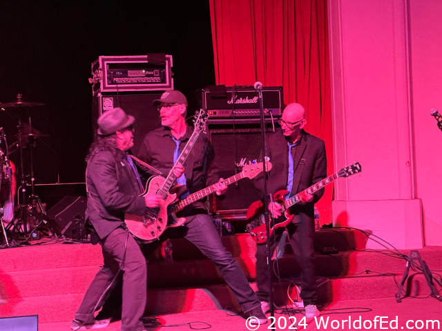 Stan, Randy, and Greg playing guitar.