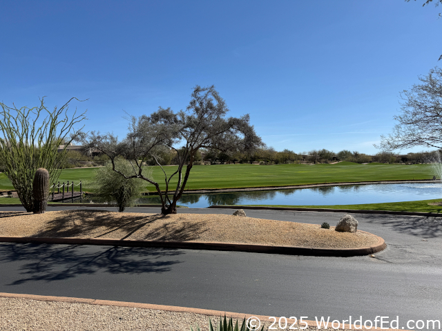 A fountain in the middle of a golf course.