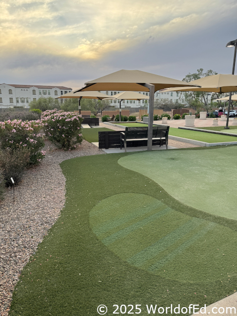 An outdoor sitting area with a putting green.