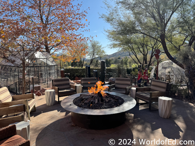 An outdoor fireplace and eating areas.