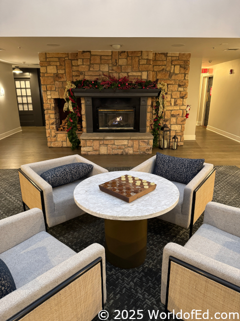 A sitting area with a smaller fireplace behind it.