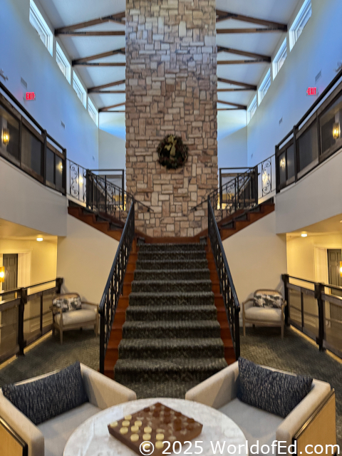 A grand staircase with a fireplace behind it.