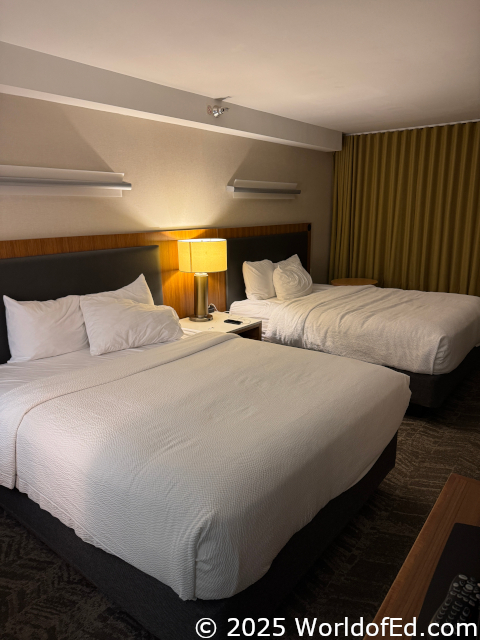 2 hotel beds in the background.