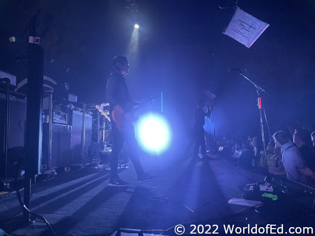 A backlit picture of the band on stage.