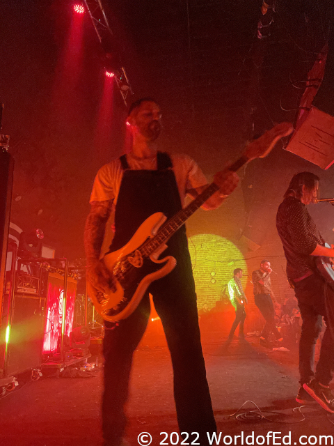 Greg playing bass on the side of the stage.