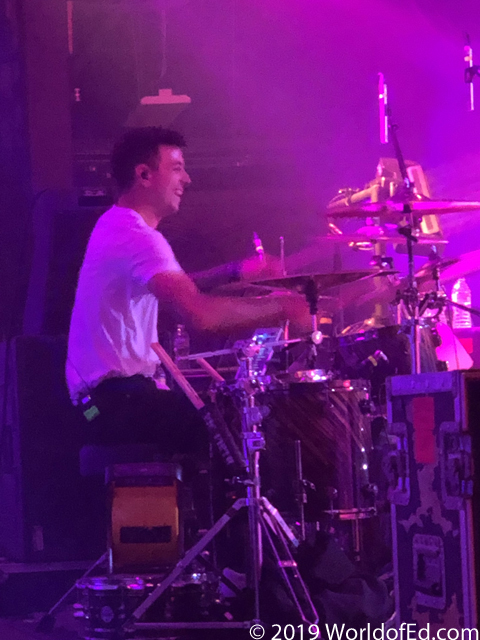 Steve Carey drumming and smiling.