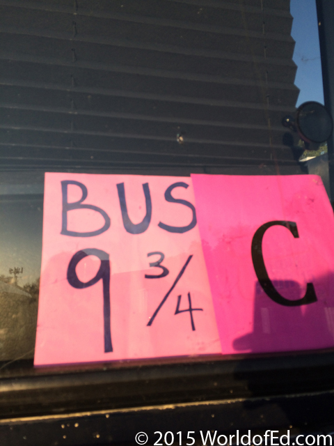 A sign in a tour bus window.