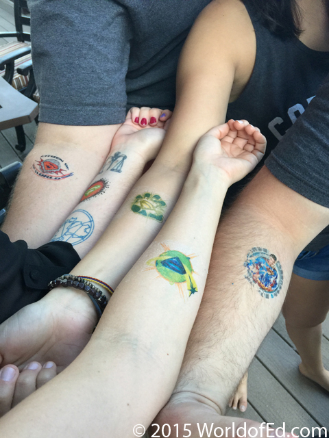 5 arms with temporary tattoos applied to them.